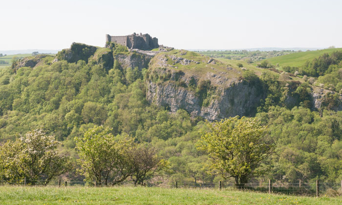 A photograph of Carreg Cennen Castle perched on top of a cliff. taken on a GeoWorld Travel Fforest Fawr Geopark geology day tour
