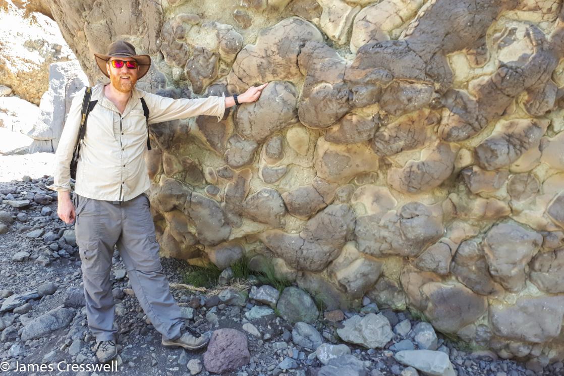 A photograph of James Cresswell pointing to pillow lavas on La Palma on a GeoWorld Travel Canary Islands geology and volcano tour, trip and holiday
