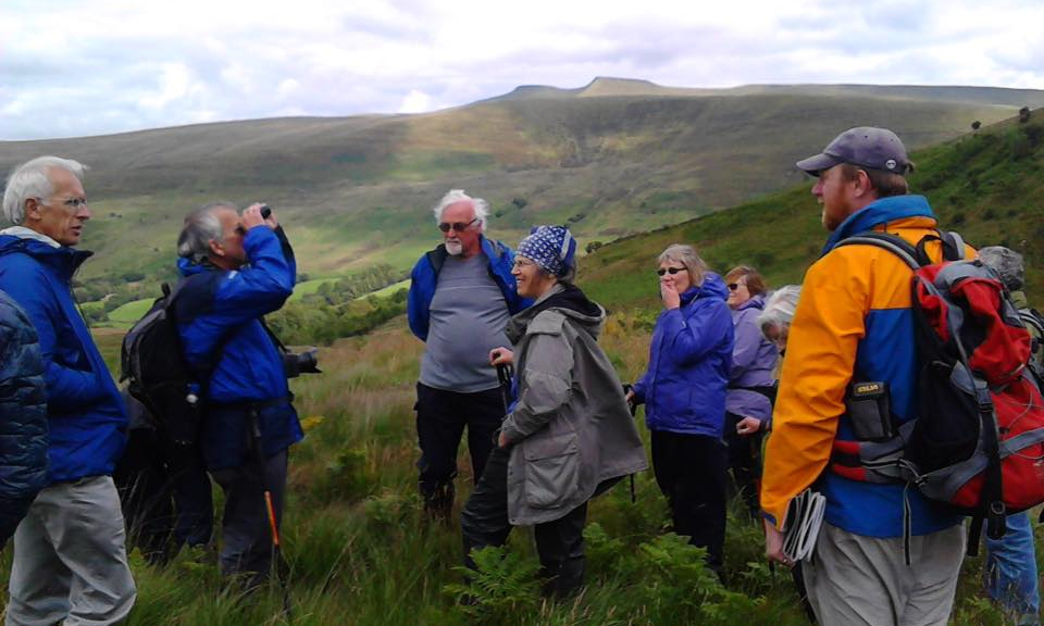 James Cresswell addresses a group of people in Craig Cerrig Gleisiad in the Brecon Beacons National Park, on a GeoWorld Travel day trip