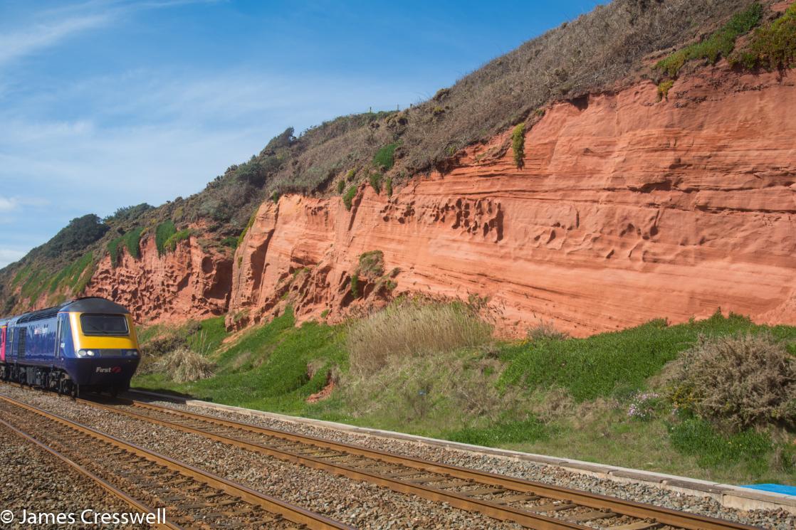 A train passes Permian aged rocks at Dawlish