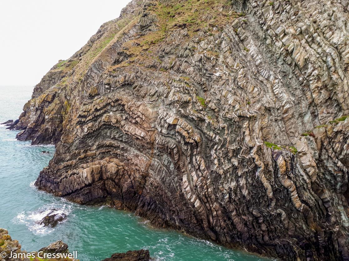 A photograph of folding in Precambrian rock at South Stack, taken on a GeoWorld Travel geology trip, tour and holiday of Wales