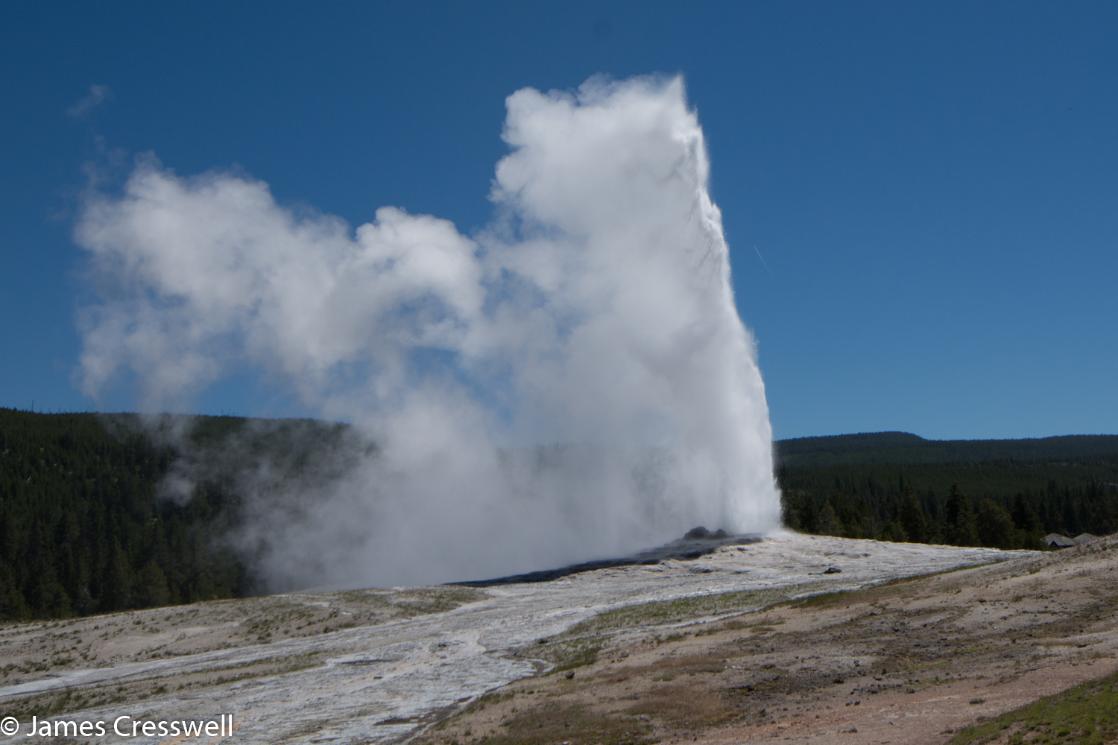 A photograph of Old Faithful geyser erupting in Yellowstone, taken on GeoWorld Travel geyser trip and holiday