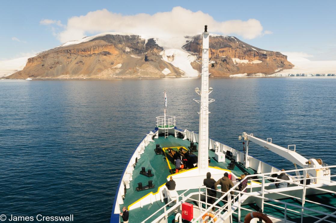 A photograph of a glacier flowing down an extinct englacial volcano in Antarctic Sound, at the entrance of the Weddell Sea, Antarctica.