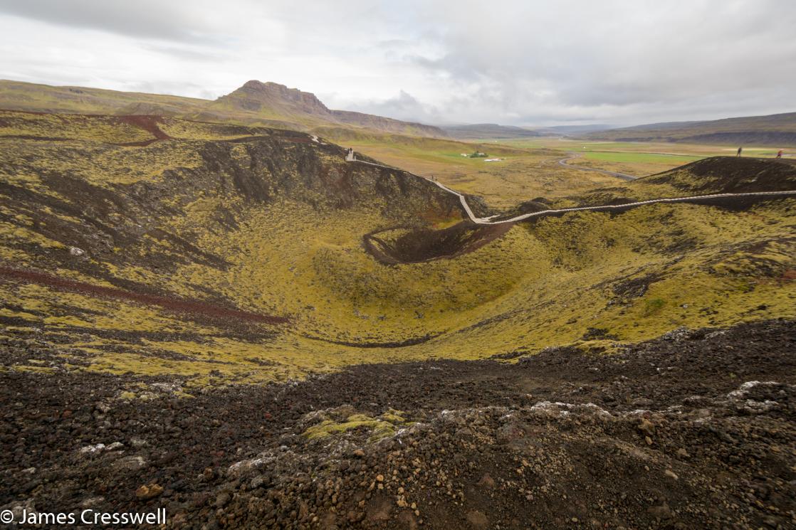 A photograph of a volcanic crater with a board walk, the Grabrok volcano, taken on a GeoWorld Travel Iceland geology trip and volcano holiday