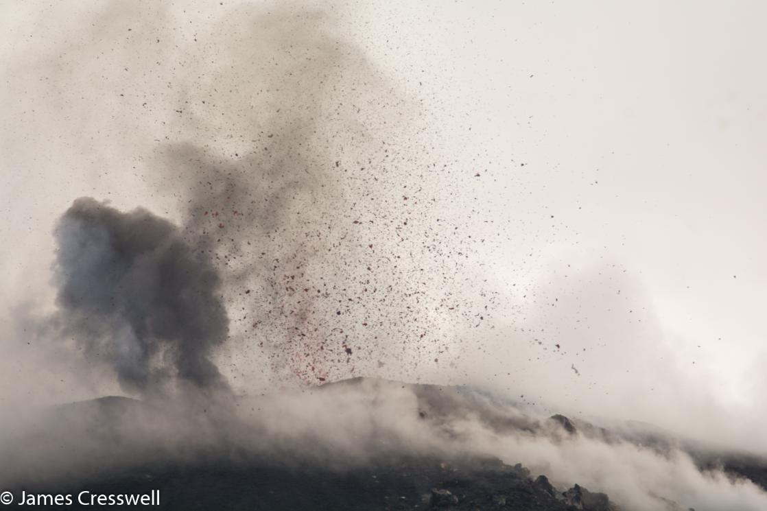 A day time photograph of Stromboli volcano erupting taken on a GeoWorld Travel Italy volcano and geology trip, tour and holiday