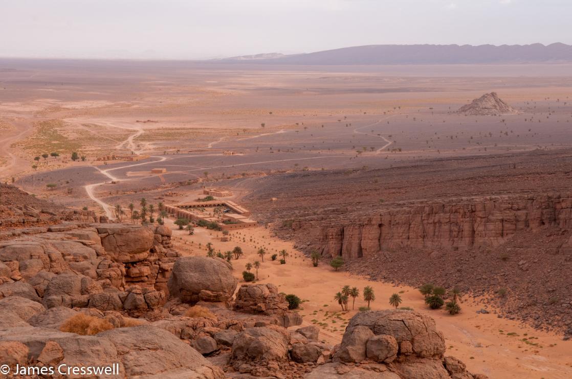 A photograph of an isolated building in a pass through rocks, the Mharch desert Oasis, taken on a GeoWorld Travel fossil, geology trip, tour and holiday