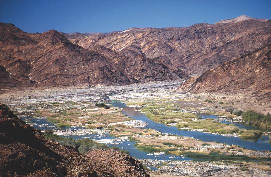 A river valley with mountains in the background