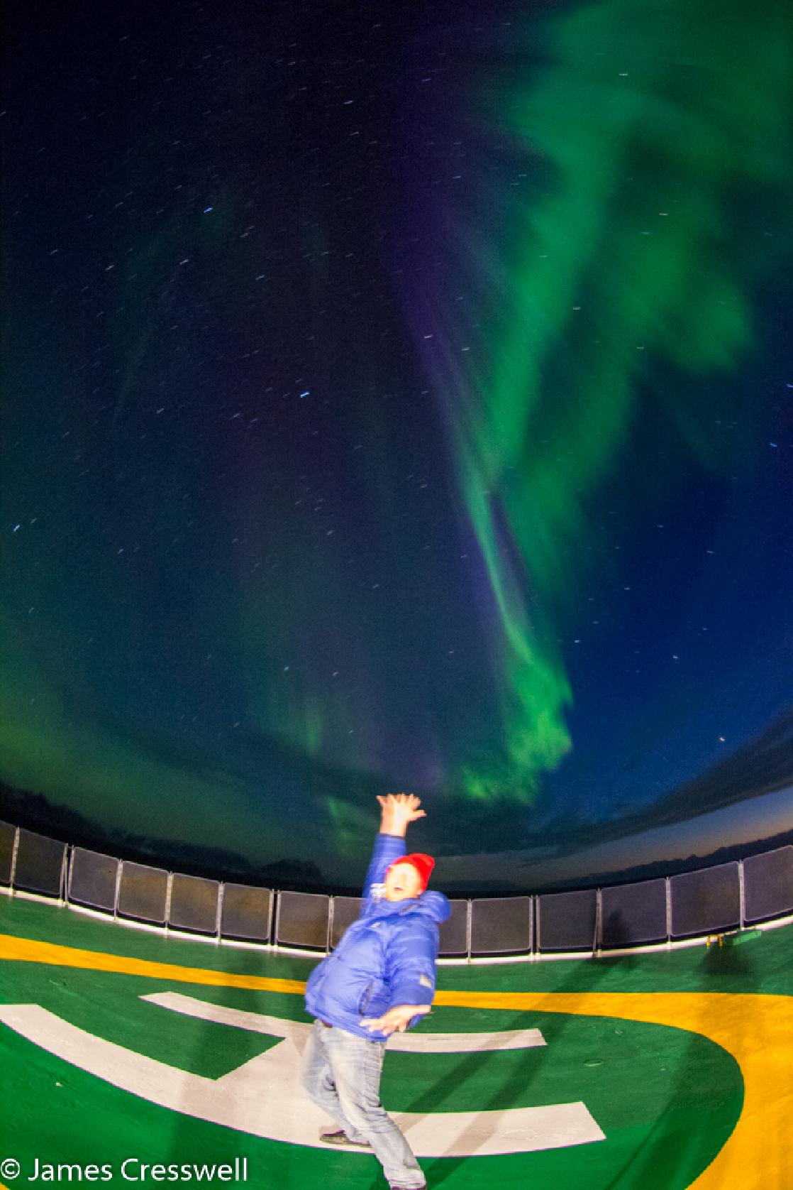 A photograph of James Cresswell and the Northern Lights in Greenland, taken on a PolarWorld Travel places expedition cruise