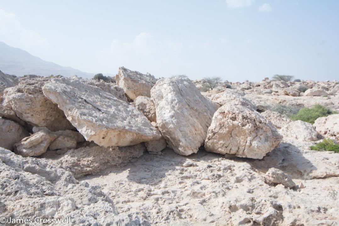 A photograph of stacked up tsunami boulders, taken on a GeoWorld Travel Oman geology trip, tour and holiday