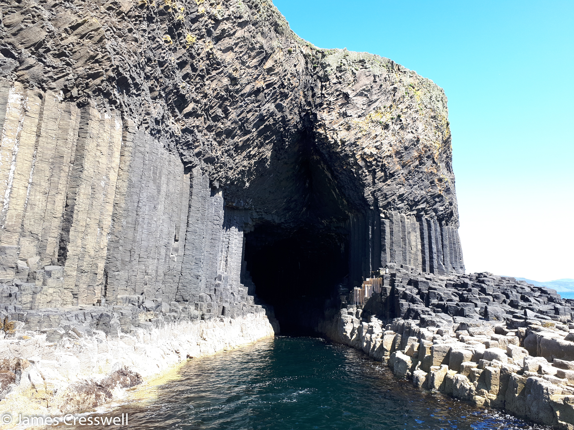 A photograph from a boat of the entrance to Fingal's Cave on Staffa, taken on a GeoWorld Travel Scotland geology trip, tour and holiday