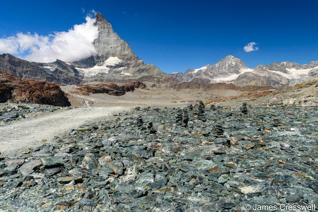 A photo of ophiolitic rocks and the Matterhorn