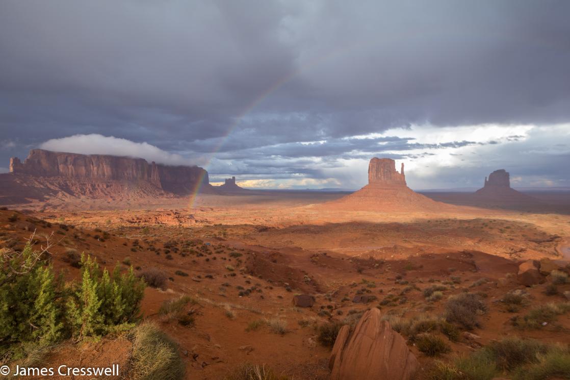 A photograph of Monument Valley with a rainbow, taken on a GeoWorld Travel USA geology trip, tour and holiday
