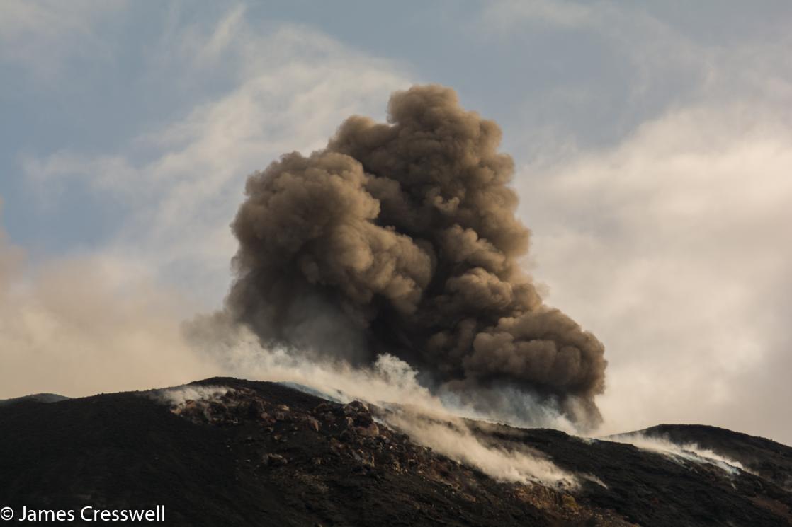 A daylight photograph of Stromboli volcano erupting, taken on a GeoWorld Travel volcano trip, tour and holiday